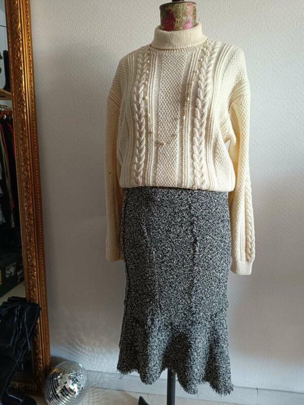 Superbe maille torsadée vintage en laine, au style intemporel et chaleureux. Son jeu de torsades verticales et son col légèrement montant en font une pièce élégante et confortable, idéale pour la saison automne/hiver.