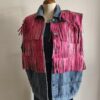 Originale veste sans manches en jean LM Lulu revisitée avec de larges franges roses et clous dorés qui lui donnent un style audacieux et très mode. Sa coupe ample permet de la porter facilement sur une robe, un top ou une chemise pour apporter une touche rock et bohème à une tenue. Une pièce forte qui attire immédiatement le regard.